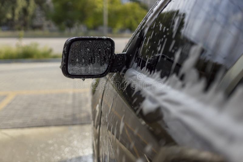 Washing Mirrors in a Car with Active Foam. Car Wash. Stock Photo