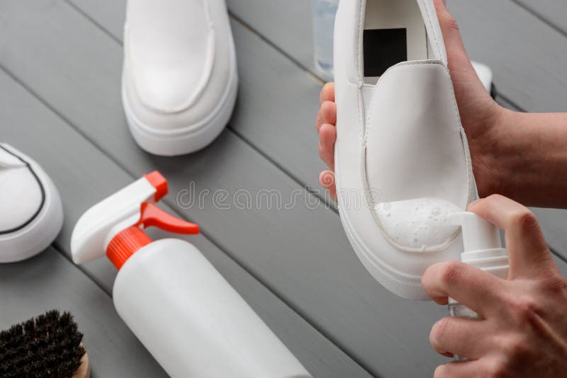 Washing Shoe with Foam Cleaner. White Leather Footwear and