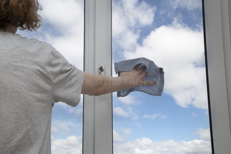 Washing the windows of the house with cleaning agents royalty free stock photo