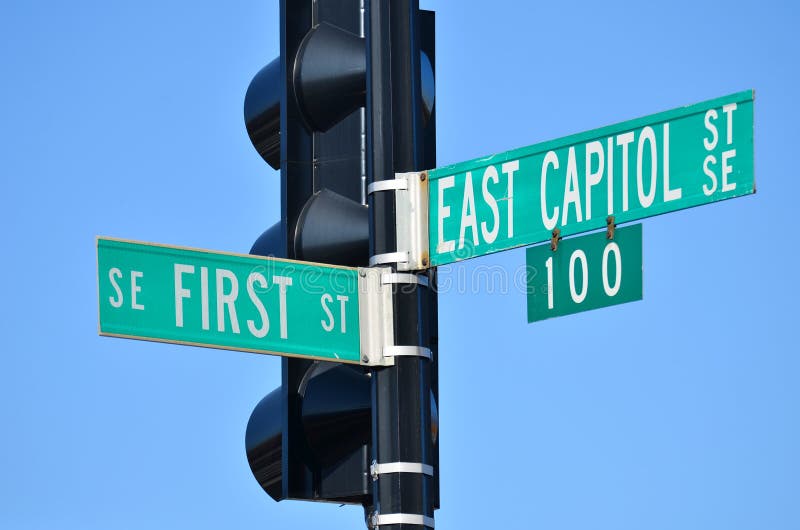 Washington DC - East Capitol Street and First Street junction street sign posted on traffic lamp pol.