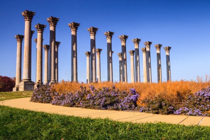 The National Capitol Columns is a monument located in Washington DC's National Arboretum. Designed in the Corinthian style, twenty-two columns are submerged in twenty acres of open meadow, known as the Ellipse. The National Capitol Columns is a monument located in Washington DC's National Arboretum. Designed in the Corinthian style, twenty-two columns are submerged in twenty acres of open meadow, known as the Ellipse.