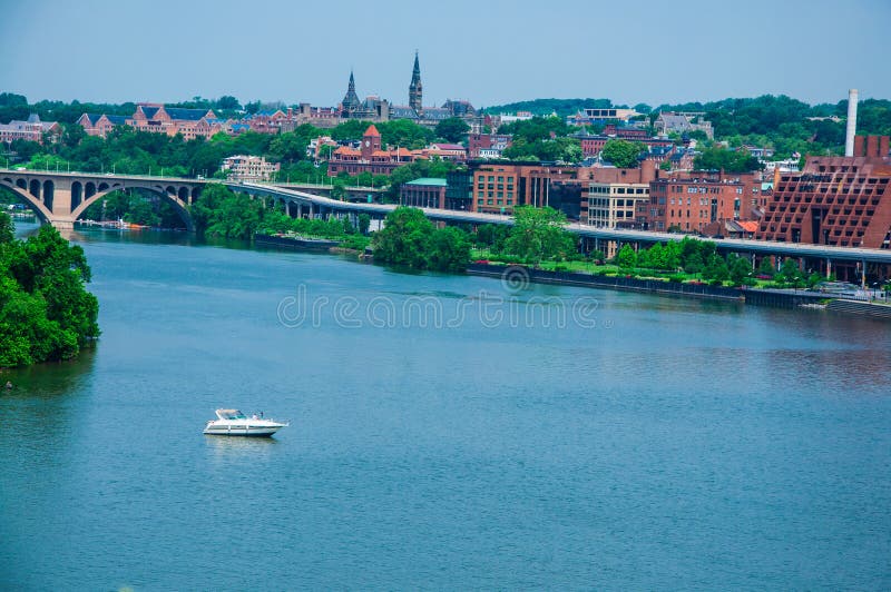 Elevated view of Washington DC by the Potomac river. In the picture are Key bridge, and Georgetown waterfront park and harbor. Elevated view of Washington DC by the Potomac river. In the picture are Key bridge, and Georgetown waterfront park and harbor.