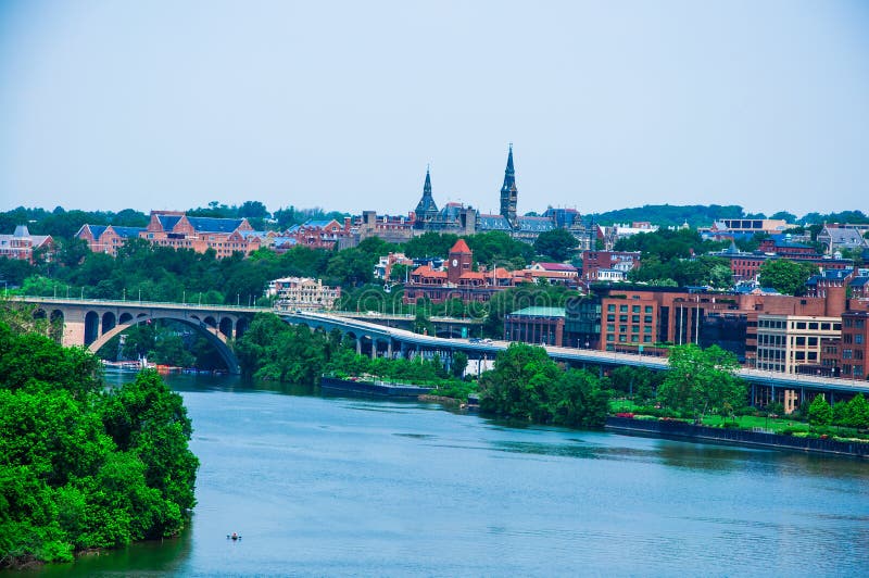 Elevated view of Washington DC by the Potomac river. In the picture are Key bridge, and Georgetown waterfront park and harbor. Elevated view of Washington DC by the Potomac river. In the picture are Key bridge, and Georgetown waterfront park and harbor.