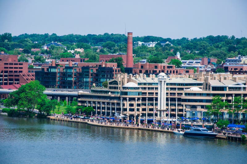 Elevated view of Washington DC by the Potomac river. In the picture are Key bridge, and Georgetown waterfront park and harbor. Elevated view of Washington DC by the Potomac river. In the picture are Key bridge, and Georgetown waterfront park and harbor.