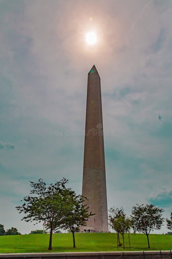 Washington Monument with the midday sun captured on top.