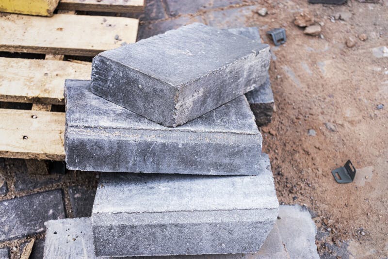 Waste from the Concrete Curb after Pavement Works is Lying on the