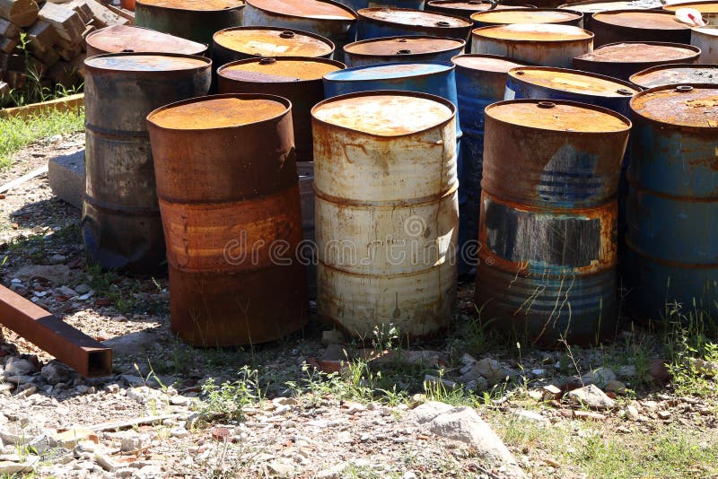 Waste ground with rusting oil drums.