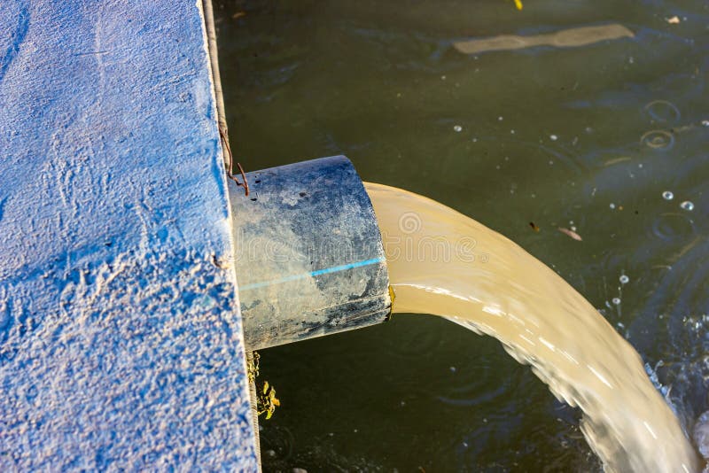 Wastewater sewage pipe dumps the dirty contaminated water into the river. Water pollution, environment contamination stock photo Wastewater sewage pipe dumps the dirty contaminated water into the river. Water pollution, environment contamination stock photo
