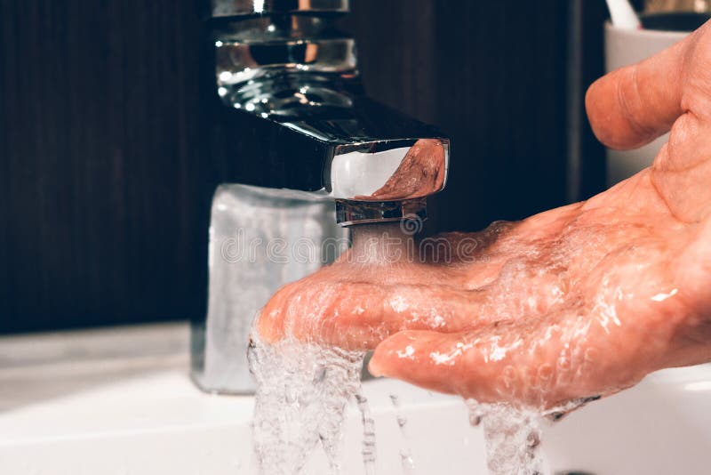 Checking the Temperature by Touching the Running Water with Your Hand