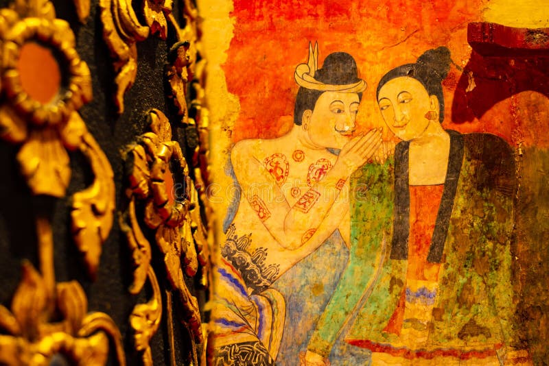 Wat Phumin NAN ,THAILAND - 2019 July 15 the tourist take photo The famous mural painting of a man whispering to the ear of a woman