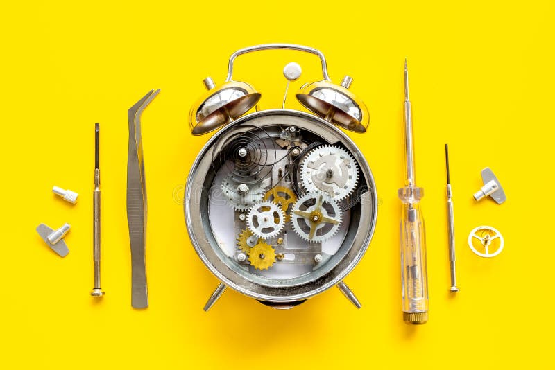 Watch Mechanism and Watchmaker Tools Near Open Alarm Clock Stock Image