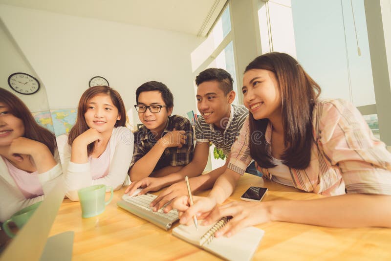 The students are watching. Asian students networking photo. Glasses Asian student.