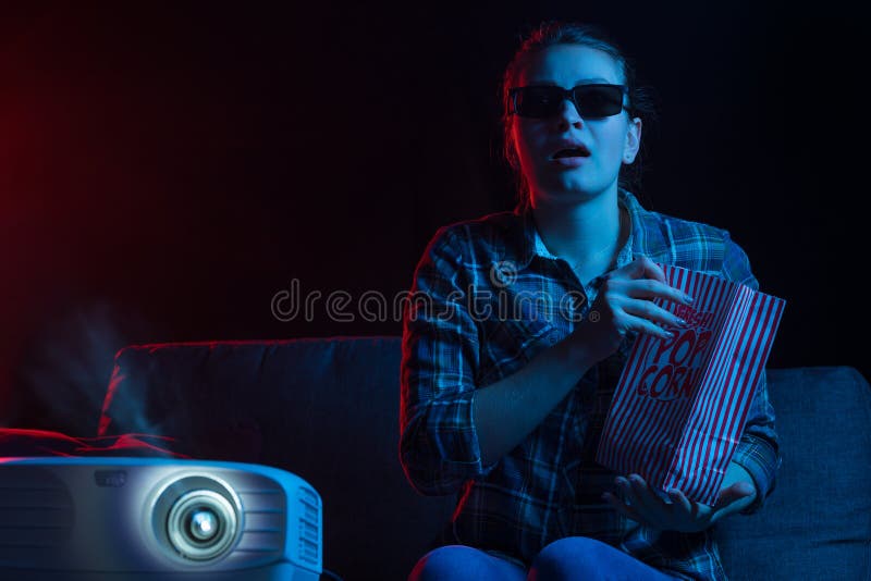 Watching movies in cinema and movie theaters. Girl with popcorn and relaxing. Rest time royalty free stock images Watching movies in cinema and movie theaters. Girl with popcorn and relaxing. Rest time royalty free stock images