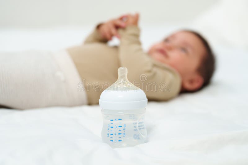 Baby Drinking Water from Bottle on Bed Stock Photo Image of white