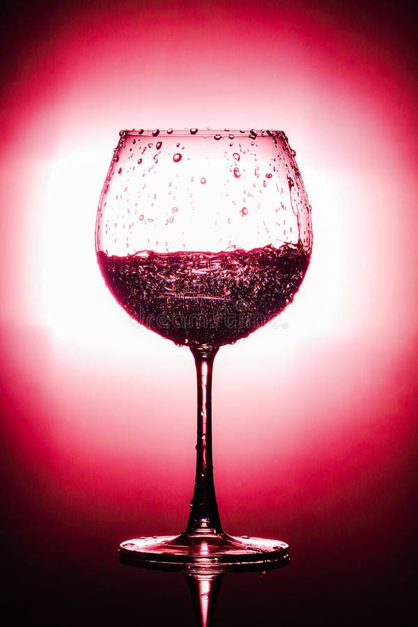 Water being poured into glass. isolated on bright red and black background stock images Water being poured into glass. isolated on bright red and black background stock images