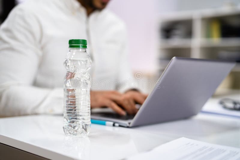 Water Bottle on Desk stock photo. Image of desk, electronic 243547362