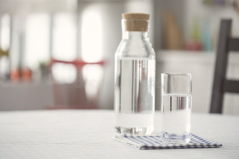 Water Bottle and Glass of Water on Kitchen Table Stock Photo Image of