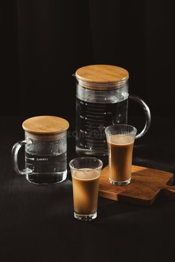 Water Bottles and Milk Coffee Glass on Dark Background Stock Image