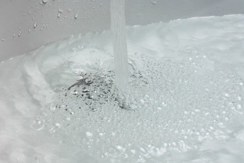 Water Drains Whirly in the Wash Sink in the Bathroom Stock Photo