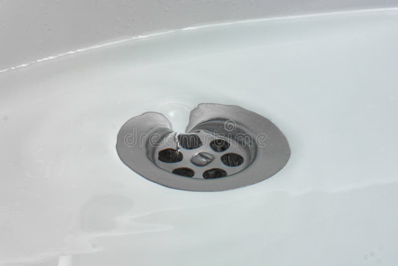 Water Drains Whirly in the Wash Sink in the Bathroom Stock Photo