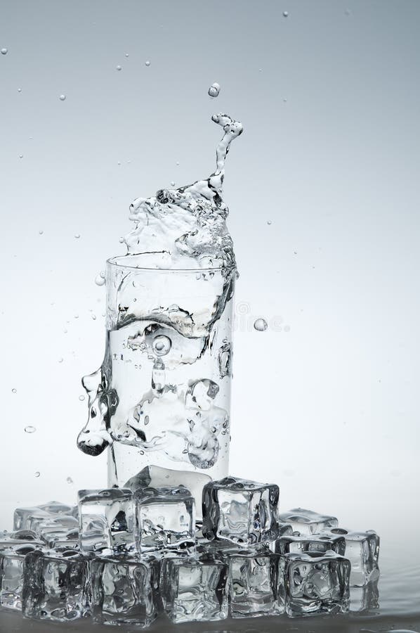 Water drink splashing out from glass stock image