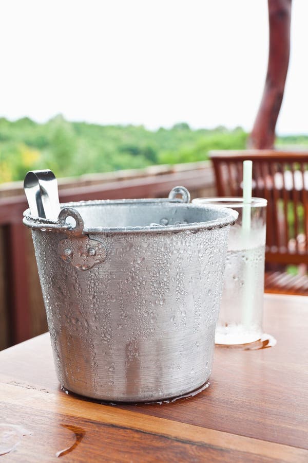 Water drop on ice bucket and table. Water drop on ice bucket and table