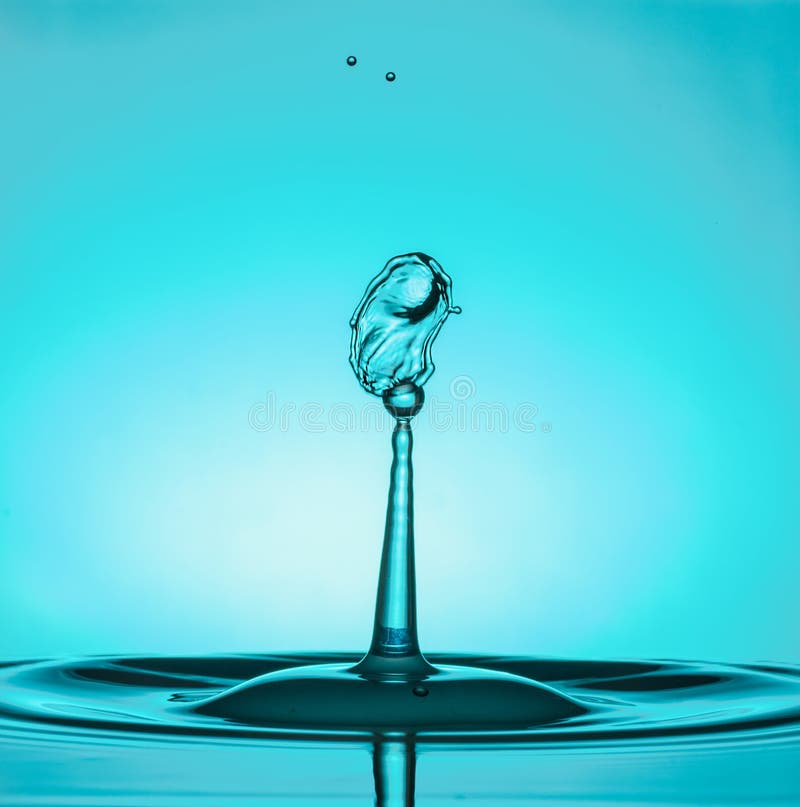 Water Drop Collisions Macro Photography with blue background royalty free stock photography