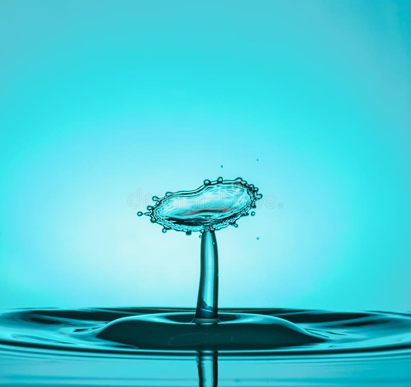 Water Drop Collisions Macro Photography with blue background stock photography