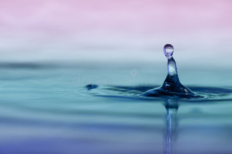 Macro shot of a water droplet impacting on liquid surface