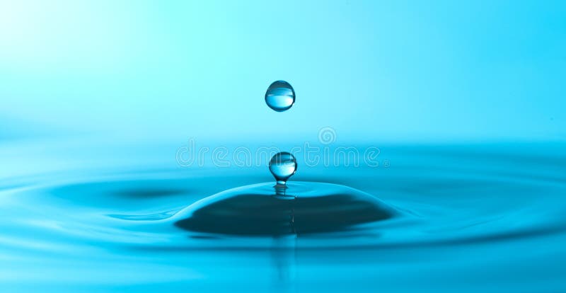 Water droplet in blue water.