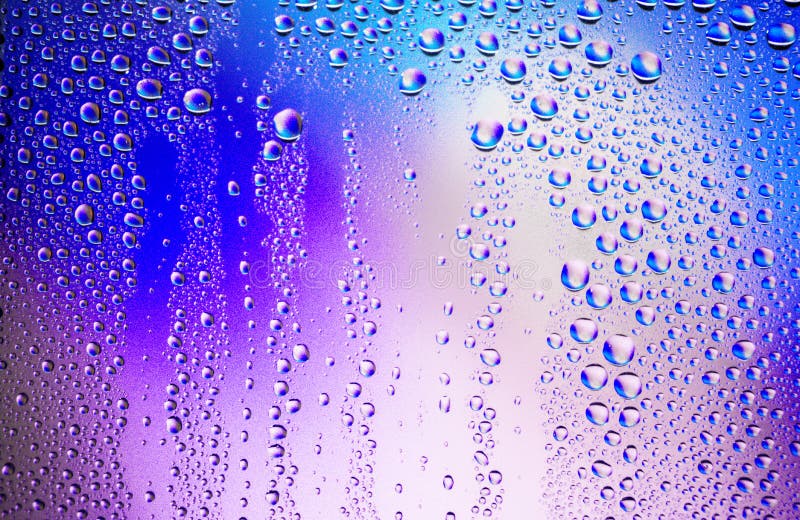 Water droplets condense on the colorful glass surface