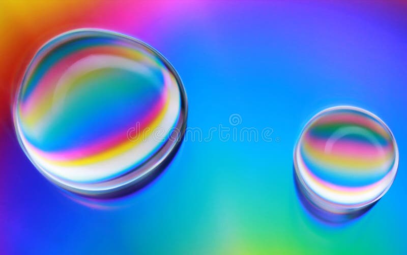 A close up photo of water drops on a cd with a rainbow background. A close up photo of water drops on a cd with a rainbow background.