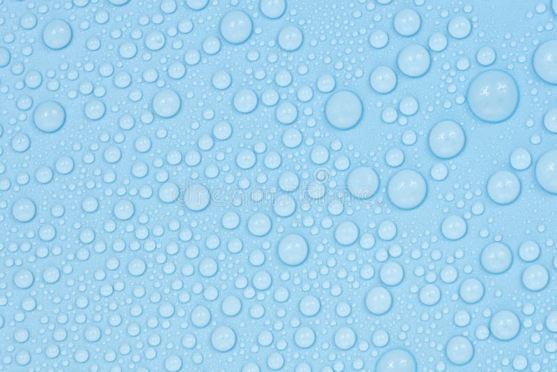 Water drops on blue background texture. Backdrop glass covered with drops of water. bubbles in water