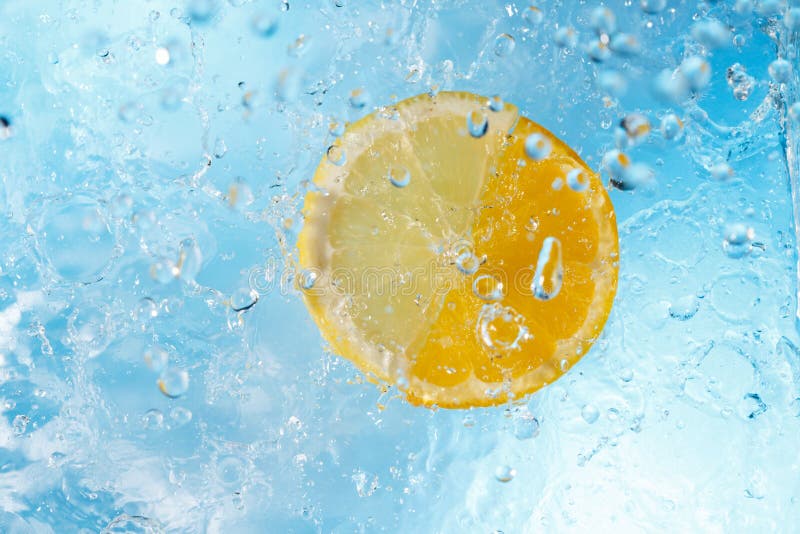 Water drops falling on lemon and orange