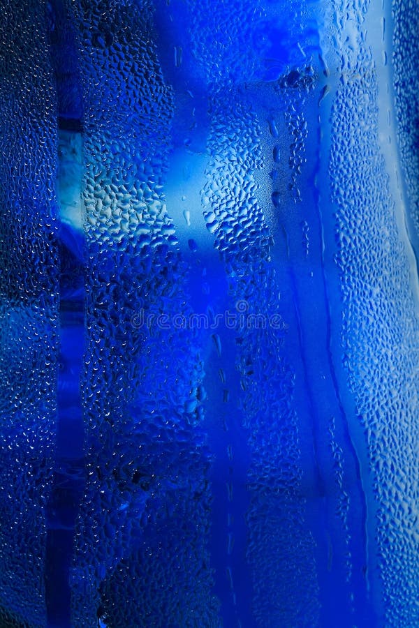 Water drops on glass with ice