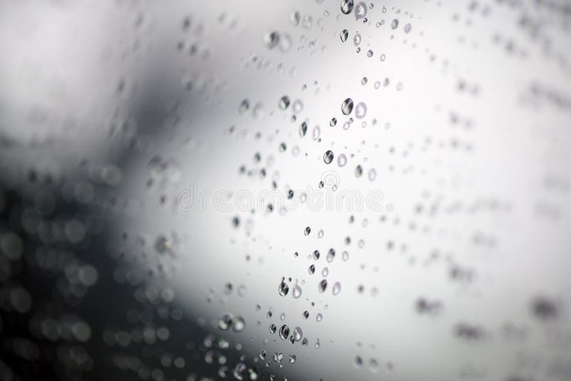 Water drops on glass..Selected focus drop of water on the glass outside the car in the raining day stock photo Water drops on glass..Selected focus drop of water on the glass outside the car in the raining day stock photo