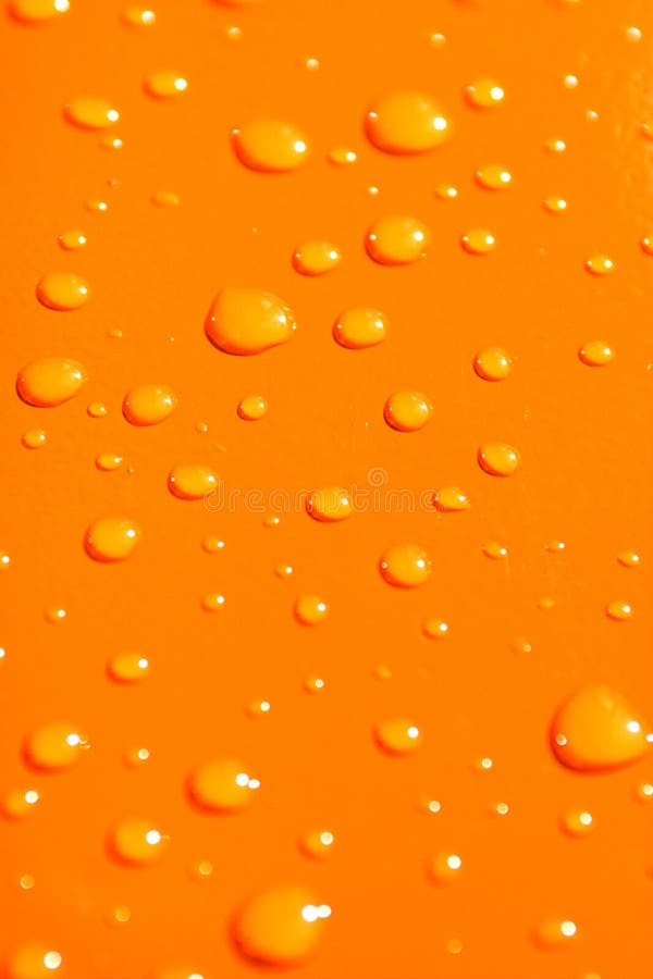 Water drops on orange metal ba