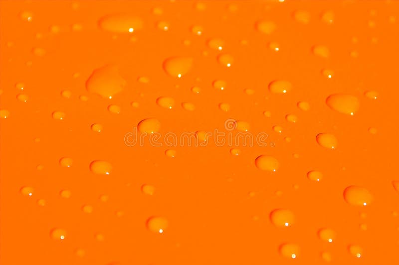 Water drops on orange metal ba