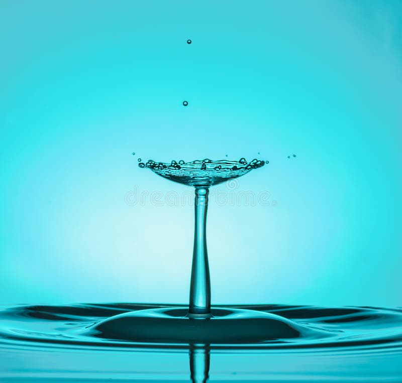 Water Drop Collisions Macro Photography with blue background royalty free stock image