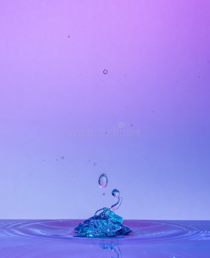 Water Drop Collisions Macro Photography with colourful background - Water drop photography stock photo