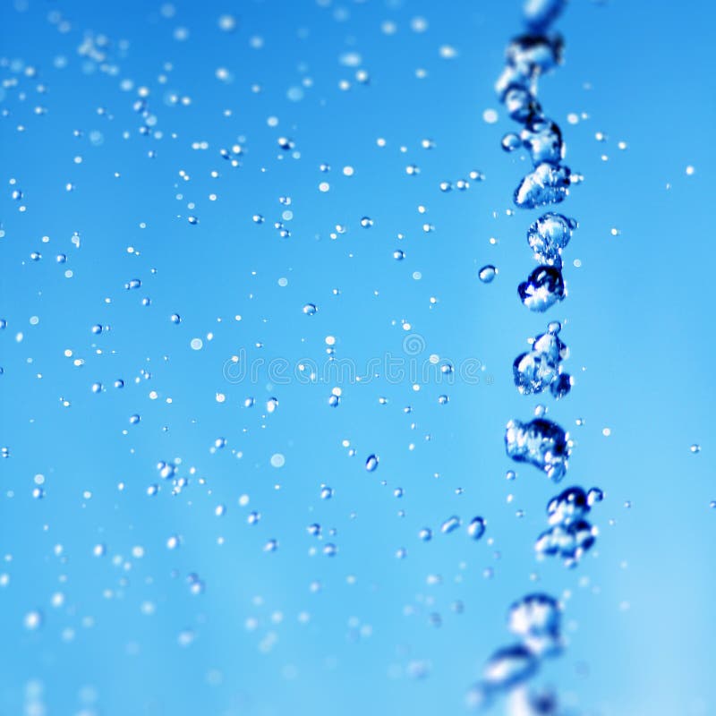 Water droplets captured in slow motion with blue background. Water droplets captured in slow motion with blue background