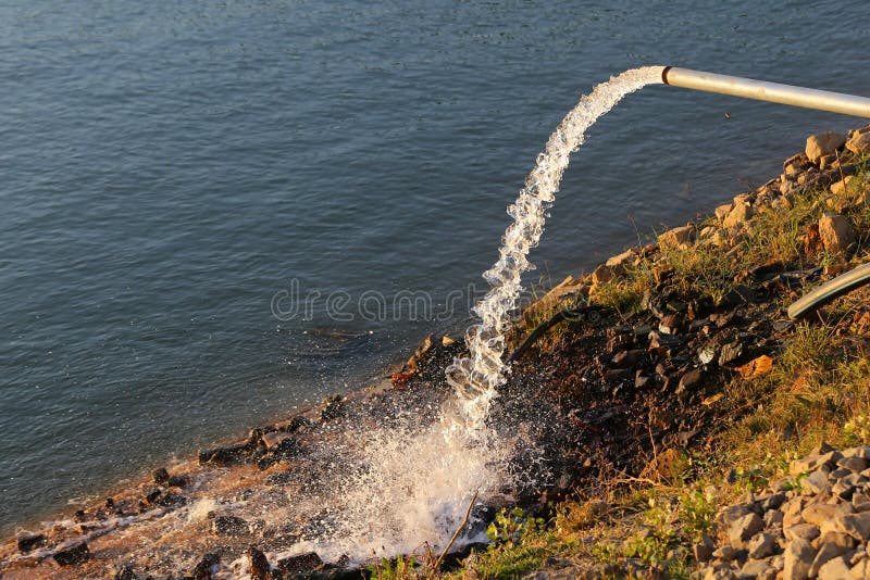 Water Flowing from a Drainage Pipe into the River Stock Photo Image