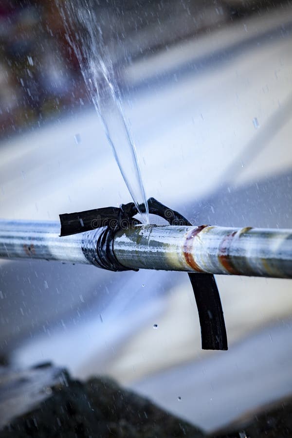 Water flowing loss from old metal pipe line stock photo