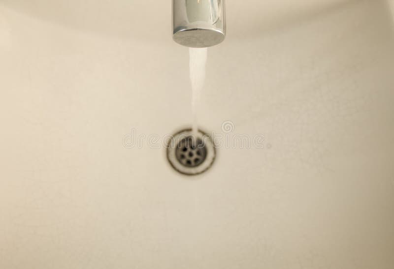 Water Flows from the Tap into the Washbasin. Clogged Water Supply
