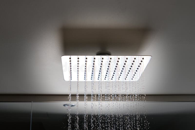 Water Flows from the Tropical Shower. Large Water Consumption. Chrome Shower Head, Modern Design