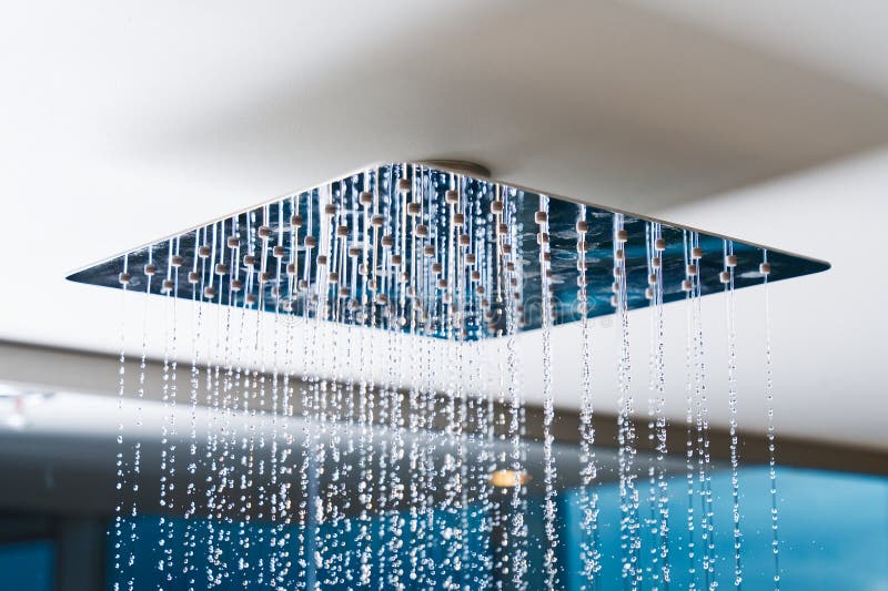 Water Flows from the Tropical Shower. Large Water Consumption. Chrome