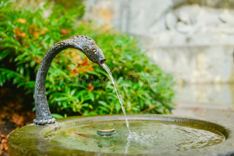 Water fountain near memorial of dying lion in Lucerne, Switzerland