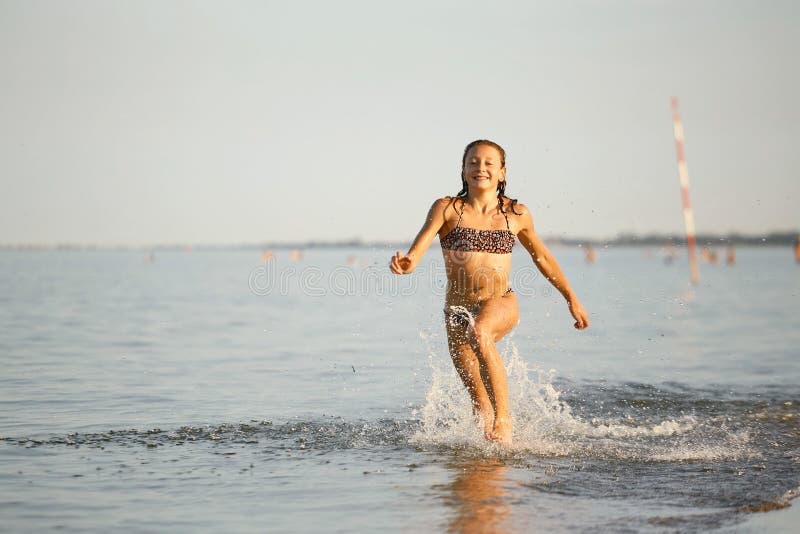 Water Fun The Girl Runs Along The Seashore Stock Image Image Of Active Holiday 110118357