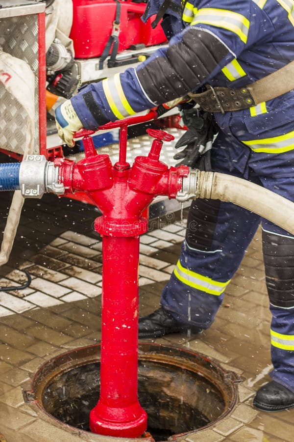 Water hydrant and firefighter turns taps stock images