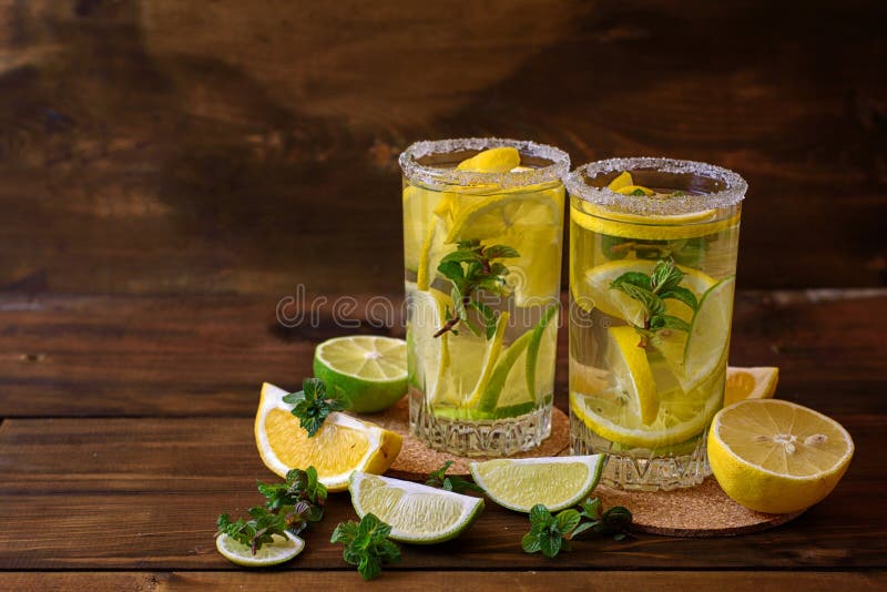 Water with Lime, Lemon and Mint Leaves on a Dark Wooden Background